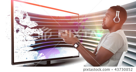 Composite image of man playing video game against white background Composite image of man playing video game against white background 43730852
