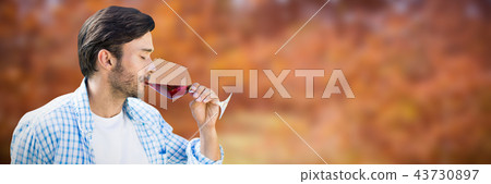 Composite image of man drinking red wine 43730897