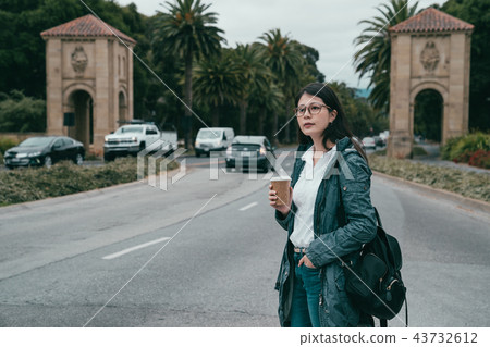 woman standing in the entrance of university woman standing in the entrance of university 43732612