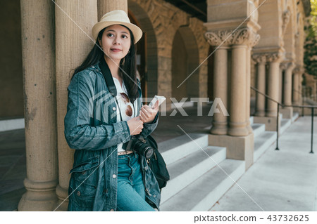 woman holding guidebook and visiting a place woman holding guidebook and visiting a place 43732625