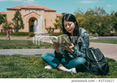 student sitting on ground and reading student sitting on ground and reading 43732627