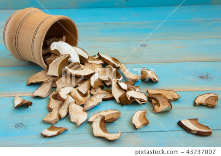 Dried mushrooms, on a blue wooden table 43737007