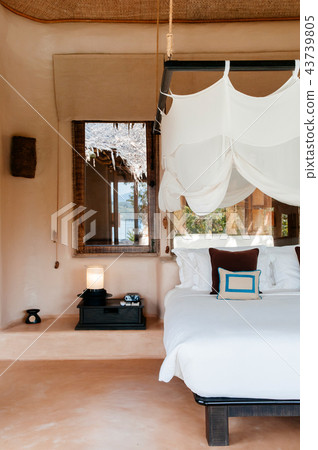 Resort bedroom with wooden bed with mosquito net Resort bedroom with wooden bed with mosquito net 43739805