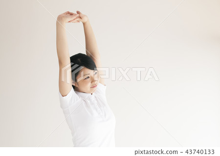 A young woman stretching A young woman stretching 43740133
