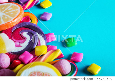sweets are different on blue background, lollipops, gum, candies 43740329