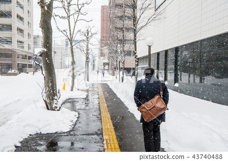 People walking in heavy snow People walking in heavy snow 43740488