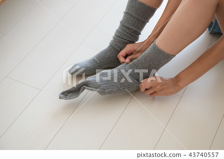 Foot of young woman wearing socks Foot of young woman wearing socks 43740557