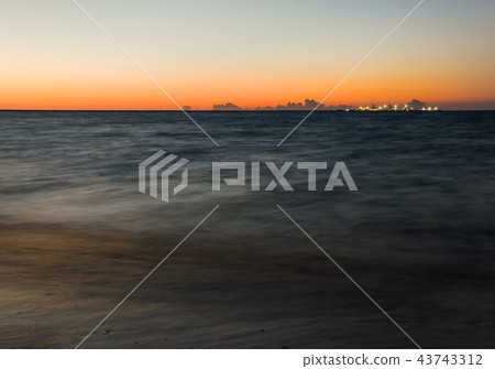 Long exposure shot of dark sea with ships pier Long exposure shot of dark sea with ships pier 43743312