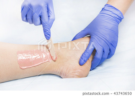 Process depilation female legs and hands in a beau Process depilation female legs and hands in a beau 43743650