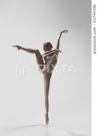 Ballerina. Young graceful female ballet dancer dancing at studio. Beauty of classic ballet. 43744386