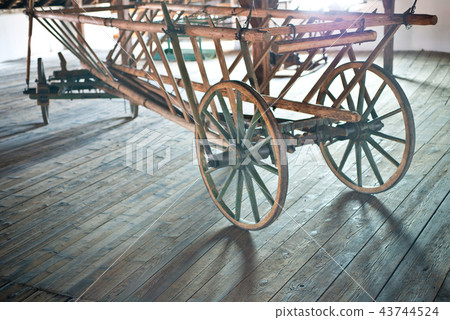 Old wooden hay wagon in the barn. 43744524