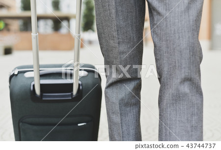 businessman pulling a trolley case businessman pulling a trolley case 43744737