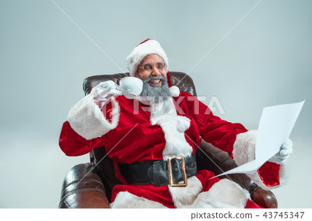 Funny guy in christmas hat. New Year Holiday. Christmas, x-mas, winter, gifts concept. Funny guy in christmas hat. New Year Holiday. Christmas, x-mas, winter, gifts concept. 43745347