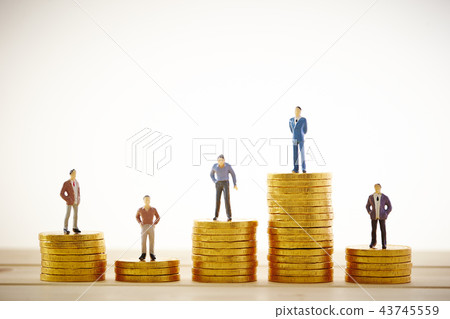 Figure of businessman standing on a gold coin Figure of businessman standing on a gold coin 43745559