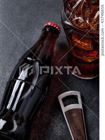 Bottle of cola soda drink and glass with ice cubes 43746656