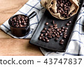 coffee beans in cup and bag on wooden background 43747837