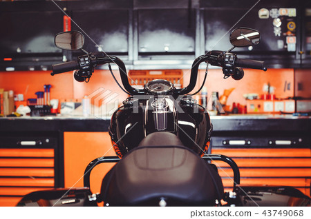 motorcycles on the floor with workshop tools,  43749068
