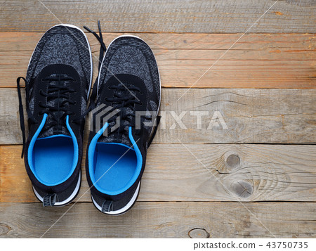Sneakers on wooden background top view Sneakers on wooden background top view 43750735