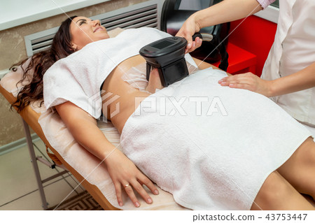 Woman cryolipolysis fat treatment, cosmetic clinic 43753447