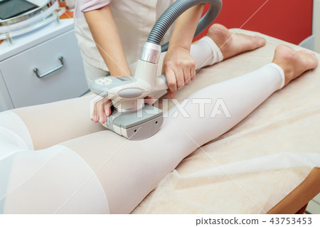 Woman having lpg massage, cosmetology clinic Woman having lpg massage, cosmetology clinic 43753453