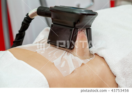 Woman cryolipolysis fat treatment, cosmetic clinic 43753456