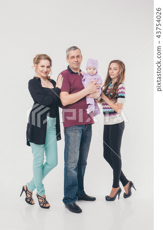 newborn baby surrounded by man, woman and girl 43754026