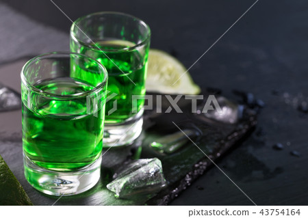 Two glasses of absinthe with lime and ice 43754164
