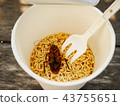 Cockroach dead in noodle cup on the table 43755651