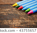 Multi color crayon on wood board with copy space 43755657