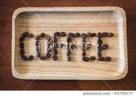 Coffee beans arranged text " Coffee " on wooden Coffee beans arranged text " Coffee " on wooden 43756577