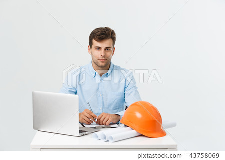 Handsome male construction engineer working in the office with laptop 43758069