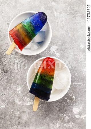 Rainbow ice cream popsicle on a gray background 43758895
