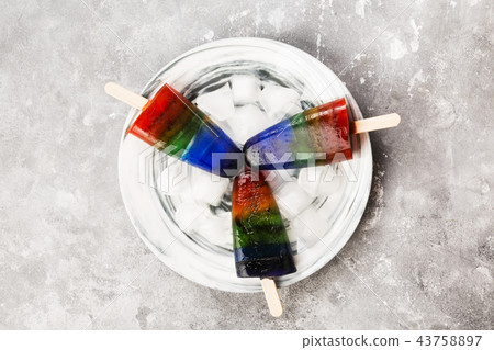 Rainbow ice cream popsicle on a gray background 43758897