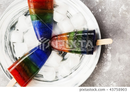 Rainbow ice cream popsicle on a gray background 43758903