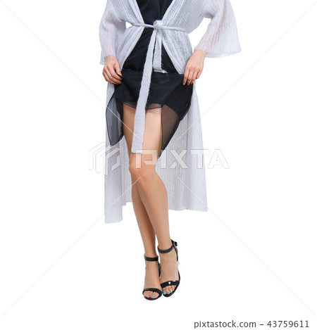 Female legs in high heel shoes with lifted dress 43759611