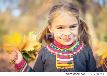 Happy little girl with autumn leaves 43760441
