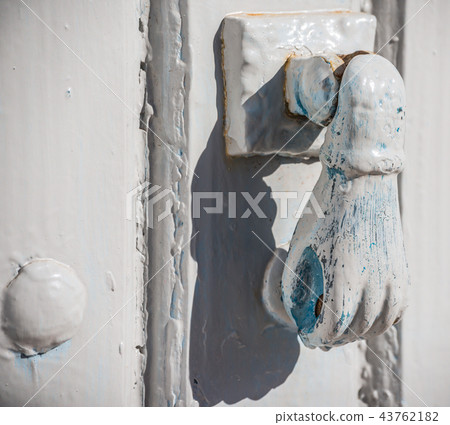 Door with brass knocker in the shape of a hand Door with brass knocker in the shape of a hand 43762182