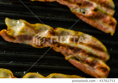 thin slices of delicious bacon fried on the grill thin slices of delicious bacon fried on the grill 43762753
