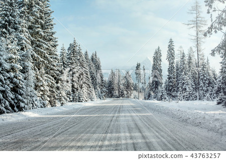 View from a car riding through snow covered road, 43763257