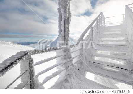 Snow and ice covered stairs, with strong backlight Snow and ice covered stairs, with strong backlight 43763266