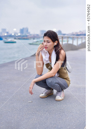Sports concept. Asian people are tired of running. Beautiful wom Sports concept. Asian people are tired of running. Beautiful wom 43764062