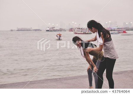 Sports concept. Asian people are tired of running. Beautiful wom Sports concept. Asian people are tired of running. Beautiful wom 43764064