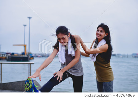 Sports concept. Beautiful girl is exercising on the beach with w Sports concept. Beautiful girl is exercising on the beach with w 43764069