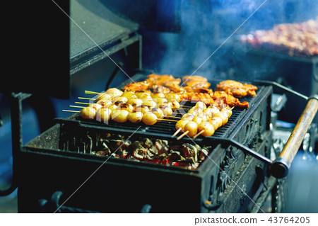 Barbecue skewer spinning on the grill. Barbecue skewer spinning on the grill. 43764205