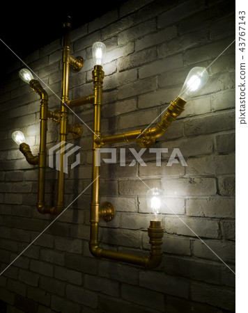 Some light bulbs glowing in a dark room. 43767143