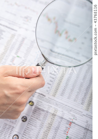 Magnifier and newspaper with hand 43768116