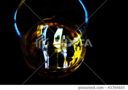 Scottish whiskey in a glass with ice cubes Scottish whiskey in a glass with ice cubes 43769885