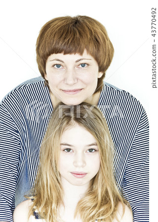 Beautiful mother and daughter on white 43770492