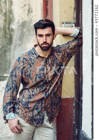 Young bearded man, model of fashion, wearing shirt in urban back 43771162