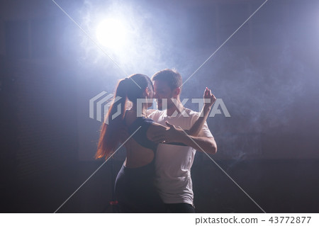 Active happy adults dancing bachata together in dance class Active happy adults dancing bachata together in dance class 43772877